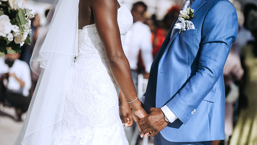 novios tomados de la mano durante la boda